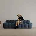 Woman Sitting On Tufted Blue Sofa Holding Baby With Dog Beside