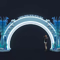 Blue Decorative Archway With Repeated Logos Illuminated Marine Decor And Person Standing Nearby