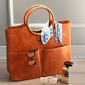 Brown Leather Tote Bag with Round Handles Scarf Sunglasses in Pockets and Perfume Bottle