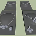 Stylish Necklaces Featuring Flower Teardrop Pendants And Pearl Accents On Black Displays