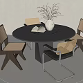 Modern Round Black Dining Table Set With Woven Seat Chairs Silver Vase And Book