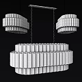 Layered Modern Chandeliers With Transparent Cylindrical Glass Tubes Brightly Illuminated Against Black Background