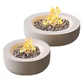 Two Round Modern Outdoor Concrete Fire Pits with Burning Flames and Decorative Pebbles