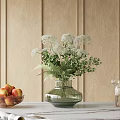 Glass Vase Holding White Flowers And Green Foliage With Apple Bowl And Wooden Wall