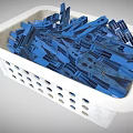White Plastic Basket Filled With Blue Clothespins For Household Use