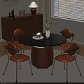 Modern Restaurant Interior Featuring Round Black Table Orange Chairs and White Vase