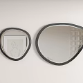 Two Different Sizes Modern Irregular Mirrors With Black Frames On White Wall