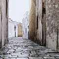 Ancient Stone Paved Alley With Weathered Walls On Both Sides Creating Rustic And Serene Atmosphere