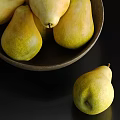 Fresh Ripe Pears Placed in Dark Bowl and Scattered Around on Black Background