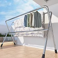 Metal Clothes Drying Rack With Hanging Shirts Jeans And Floral Blanket On Balcony