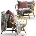Stylish Wicker Outdoor Chair With Pink Cushion And Floral Blanket For Patio Use