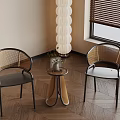 Modern Interior Space Featuring Wicker Chairs Small Round Table Potted Plant And Floor Lamp