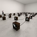 Art Installation With Vintage TVs Connected by Cables and a Person in Gallery Space