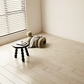 Light Hardwood Flooring In Bright Minimalist Room With Table And Cushion