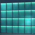 Modern Glass Block Background Wall with Vertical Striped Panels and Illuminated Lighting for Interior Decor