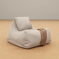 Gray Fabric Bean Bag Chair With Brown Strap On Wooden Floor And Gray Wall
