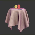 Modern Furniture Table With Beige Textured Tablecloth And Small Decorative Figurines