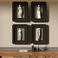 Black Framed Figure Paintings With White Female Statues On Wall