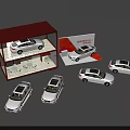 Multiple White Car Models Display With Red Roof Cabinet And Brochure Around