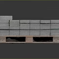 Stacked Gray Bricks on Wooden Pallet with Green Straps and Orange Label