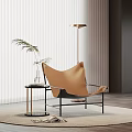 Elegant Modern Tan Leather Lounge Chair With Black Metal Frame Side Table And Floor Lamp