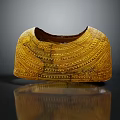 Traditional Golden Armor Accessory With Intricate Engraved Patterns And Historical Design