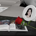 Red Rose Flower on Living Room Table Next to Open Magazine and White Photo Frame