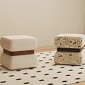 Minimalist Beige And Patterned Ottomans On Black Square Patterned Rug With Light Wall