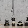 Five Black Hanging Teapots With Different Heating Devices Flames Charcoal Grey Wall And Wooden Floor