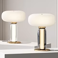 Modern Table Lamps With White Lampshades Gold Accents Transparent Black Bases On White Tabletop