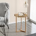 Golden Tray Top Side Table With Books Next To Gray Chair On Light Wall Gray Floor