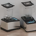Two Modern Kitchen Blenders With Black Lids Digital Displays And Silver Bases On Wooden Countertop
