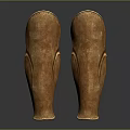 Two Shiny Golden Metallic Leg Armor With Curved Design And Glossy Finish