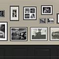 Various Size Photo Frames With Black And White Scenery Photos On Beige Wall