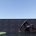 Sitting Human Sculpture by Black Wall with Water Grass and Blue Sky