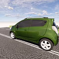 Green Compact Car Parked On Gravel Road With Blue Sky And Green Grass