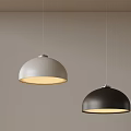 Modern White and Black Dome Shaped Pendant Lights with Warm Illumination on Neutral Wall