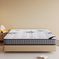 Comfortable Mattress With Patterned Surface On Bed Base Near Nightstand And Table Lamp