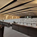 Modern Conference Room With Wooden Geometric Ceiling Gray Seats Warm Lighting And Large Blue Screen