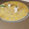 Yellow Patterned Round Rug With Vase Flowers And Green Plant On Wooden Floor