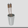 Two Decorative Wicker Covered Wooden Sticks Standing Vertically in White Ceramic Cup