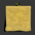Yellow Cube Shaped Food With Green Herbs And Olive Topping On Textured Surface