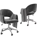 Gray Velvet Office Chair With Armrests Draped Blanket And Metal Base Wheels