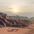 Scenic Desert Landscape With Rugged Mountain Range And Golden Sunset Sky