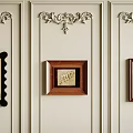 Decorative Wall Panel With Ornate Moldings And Three Framed Artworks Hanging
