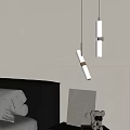 Modern Bedroom Pendant Lights Illuminating Bedside Gray Wall With Upholstered Headboard And Decorative Pillows