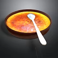 Delicious Creme Brulee With Caramelized Top In Brown Bowl And Silver Spoon