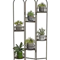 Multi Tiered Metal Plant Stand With Various Potted Plants And White Pots