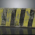 Worn Concrete Road Barrier Block With Yellow And Black Stripes And Scratches