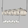 Modern Interior Pendant Lights With White Cylindrical Shades Arranged In Double Rows On Grey Wall